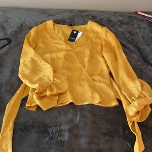 Guess Gold blouse. Peplum. Ties in back.
